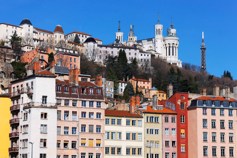 Historic European cityscape with colourful buildings and the Basilica of Notre-Dame de Fourvière on a hill in Lyon, France